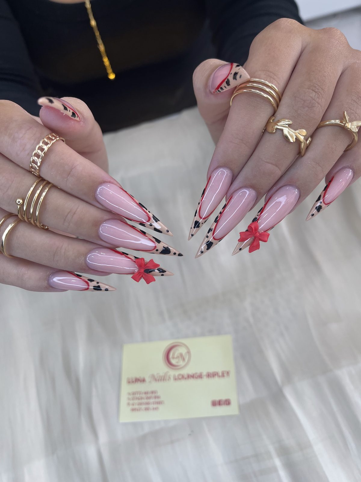 Long almond nails in pink with black and red floral art