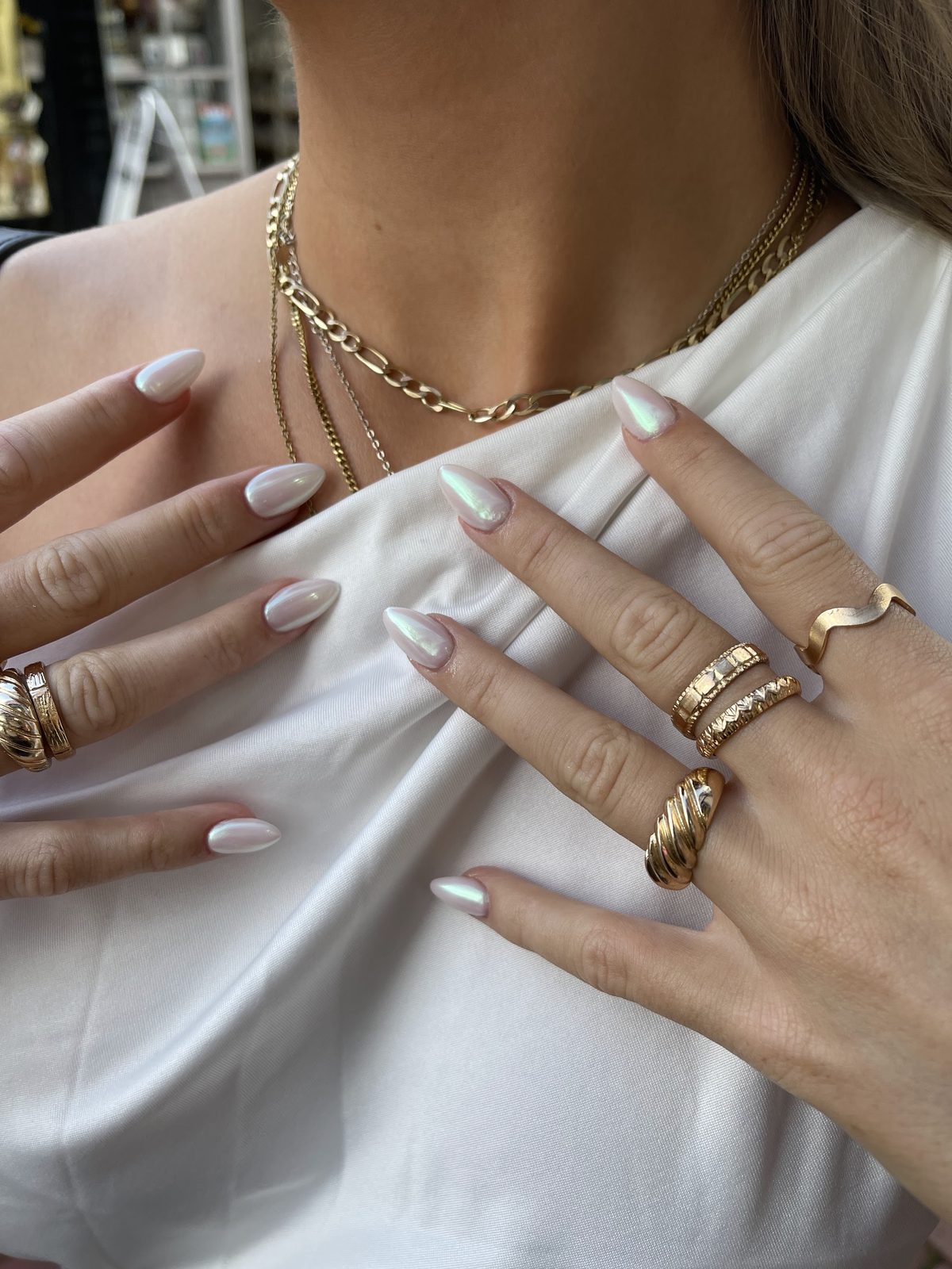 Pearl chrome almond nails with gold rings