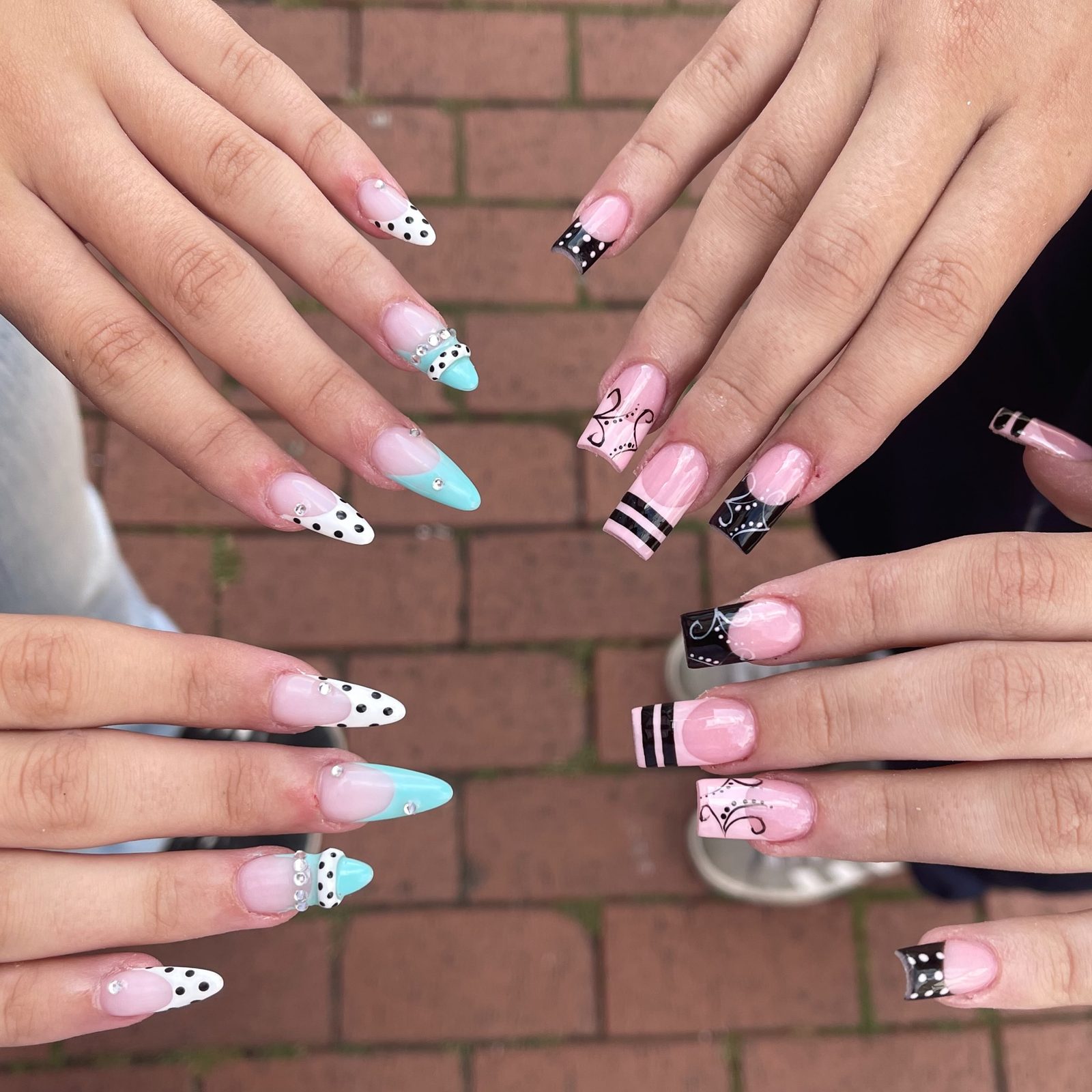 Four hands with polka dot, blue French and striped designs