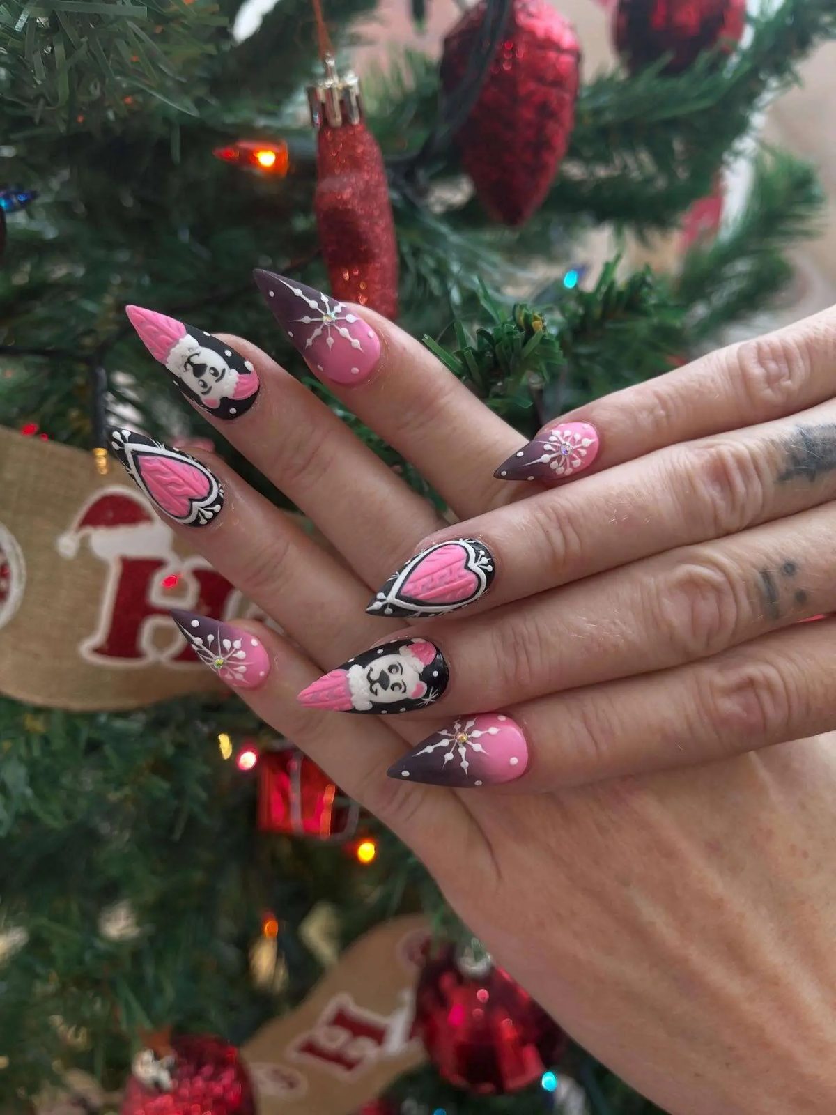 Christmas set in pink with hearts and cartoon designs by a Christmas tree
